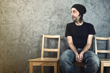 Man sitting on wooden chair and waiting