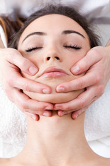 Woman enjoying massage at beauty spa