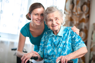 senior woman with her home caregiver - obrazy, fototapety, plakaty