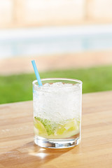 Classic caipirinha cocktail by a pool outdoors