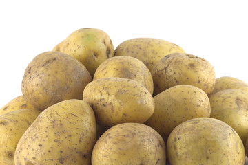 Heap of many ripe brown potatoes isolated close up