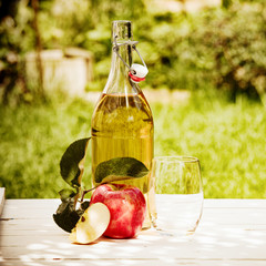 Bottled fresh apple juice served in the garden
