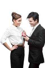 young happy business people holding red gift