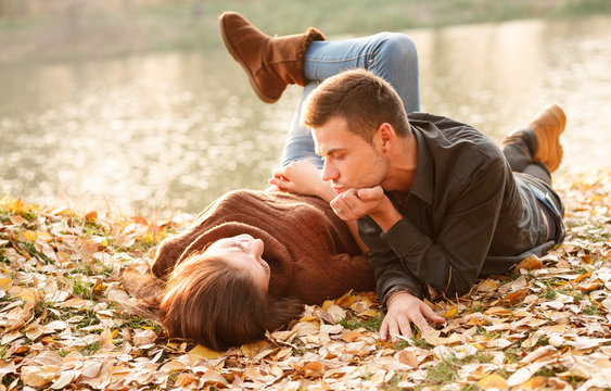 young couple lying down outdoors