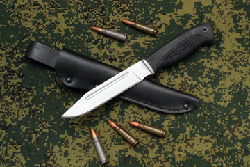 Military knife blade down on black leather sheath