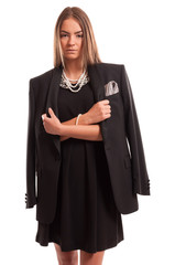 Beautiful young woman wearing a black dress and a man's jacket