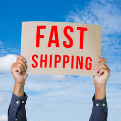Man hand holding paper with fast shipping word