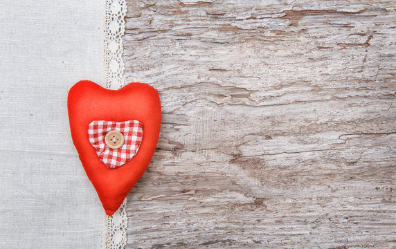 Valentine background  with textile heart on old wood