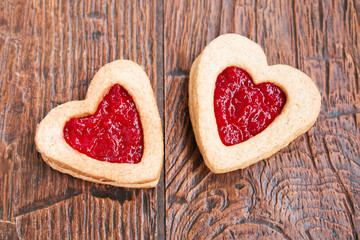Two heart-shaped cookies with jam