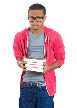 Stressed male student holding books, anxious of exams