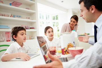 Family Using Digital Devices Having Argument Over Breakfast