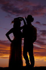 silhouette couple in western hats together