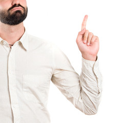 Young man pointing up over white background