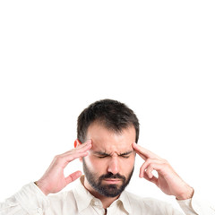 Young man with headache over white background