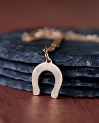 gold jewelry pendant horseshoe - symbol of luck