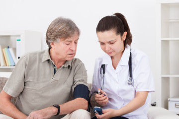 Doctor Measuring Blood Pressure Of Patient