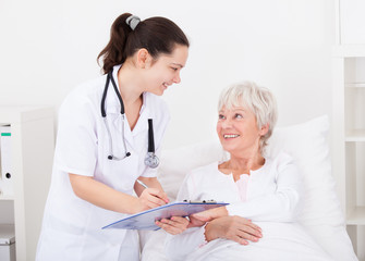 Doctor Giving Prescriptions To Patient