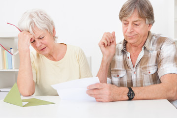 Upset Senior Couple With Letter