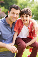 Obraz premium Portrait Of Hispanic Father And Son In Countryside