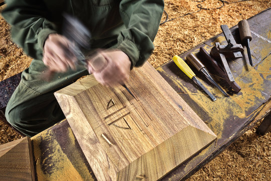 hands of the craftsman carve  with a chisel