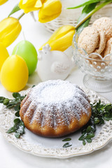 Easter cake and bouquet of yellow tulips on the table