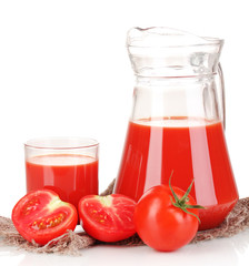 Tomato juice in pitcher and glass on sackcloth isolated on