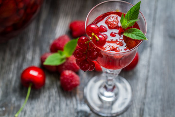 Closeup of liqueur made of fresh wild berries and mint