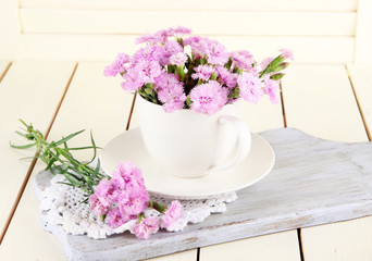 Many small pink cloves in cup