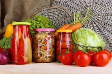 Fresh vegetables and canned on table close up