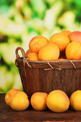 Fresh natural apricot in basket on wooden table