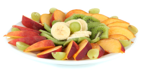 Assortment of sliced fruits on plate, isolated on white