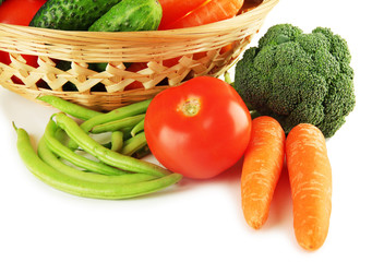 Different vegetables in basket isolated on white