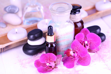 Beautiful spa setting with orchid on white wooden table