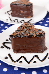 Sweet cakes with chocolate on plate on table close-up