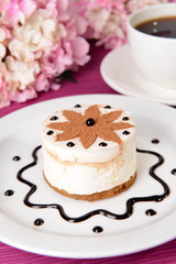 Sweet cake with chocolate on plate on table close-up