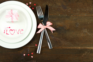 Romantic holiday table setting, on wooden background