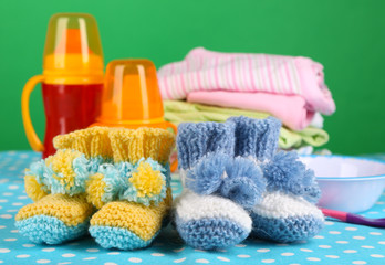 Composition with crocheted booties for baby, clothes and other
