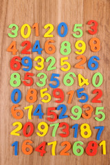 Colorful numbers on wooden background