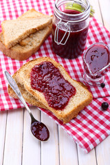 Delicious toast with jam on table close-up