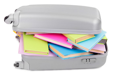 Suitcase with books isolated on white