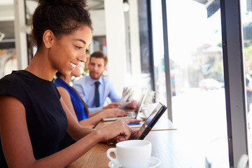 Businesswoman Using Digital Tablet In Coffee Shop