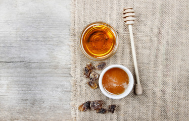 Bowl of honey on wooden table. Symbol of healthy living