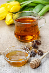 Bowl of honey on wooden table. Symbol of healthy living