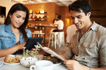 Couple Meeting In Busy Café Restaurant