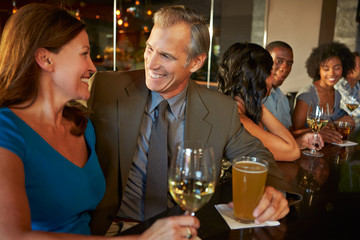 Mature Couple Enjoying Drink In Bar Together
