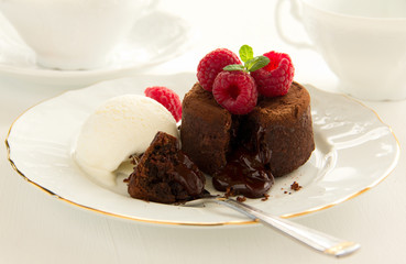 Chocolate fondant (pudding) with raspberries.