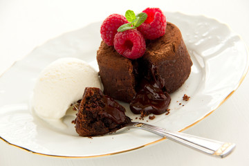 Chocolate fondant (pudding) with raspberries.