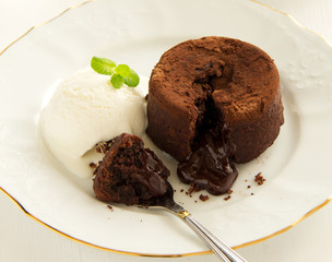 Chocolate fondant (pudding) with raspberries.