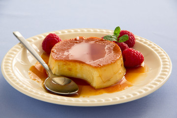 Creme caramel with raspberries.