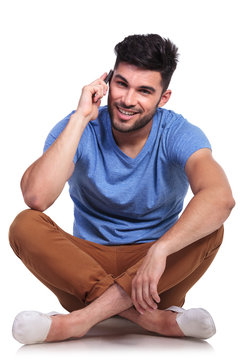 seated casual man talking on his cell phone